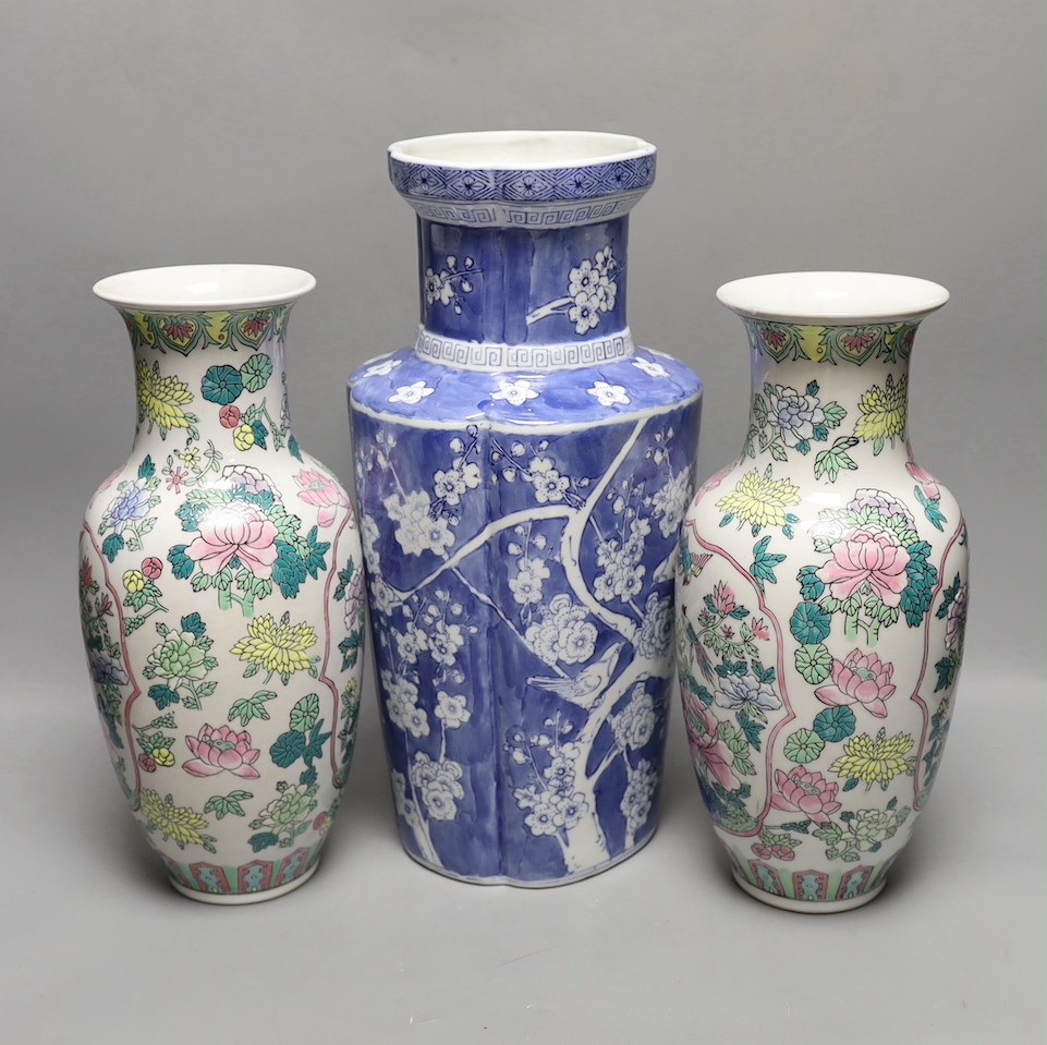 A pair of Chinese enamelled porcelain baluster vases and a Chinese blue and white vase. 37cm